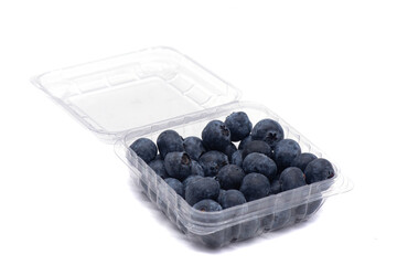 Blueberries in a plastic container on a white background