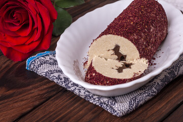 Eastern sweet halva with chocolate and rose powder on wooden background.