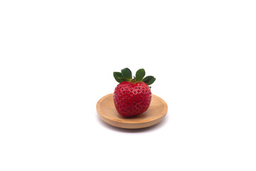 Strawberry on a wooden stand on a white background