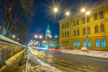 Fototapeta na wymiar Night Lviv old city architecture in the winter season. Buildings highlighted by the illumination
