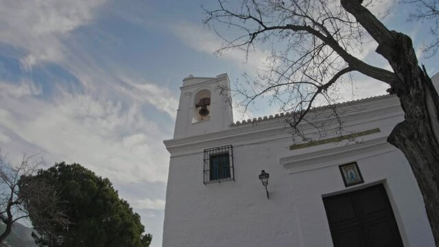Time lapse of White Church Bell Tower Against Sky, Big Tree in Foreground