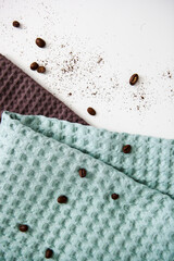 spa and relaxation towels, brown and green towels on a white background with coffee beans
