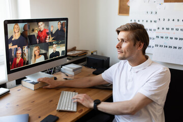 Young man having Zoom video call via a computer in the home office. Stay at home and work from home...