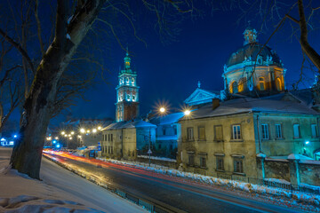 Night Lviv old city architecture in the winter season. Buildings highlighted by the illumination