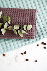 spa and relaxation towels, brown and green towels on a white background with a branch of eucalyptus