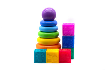 Children's multi-colored pyramid and rubber cubes on a white background
