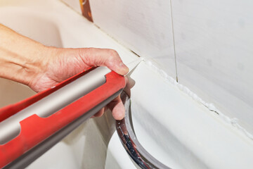 silicone pistol and silicone sealant in the bathroom glue process