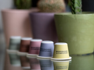 Close up of colourful, sustainable eco friendly coffee capsules. The pods are compostable and biodegradable.