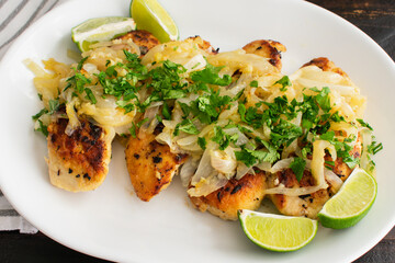 Cuban Chicken with Onions (Pollo a la Plancha) Ingredients: Raw chicken, vegetables, and seasonings used to make Pechuga a la Plancha