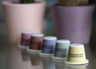 Close up of colourful, sustainable eco friendly coffee capsules. The pods are compostable and biodegradable.