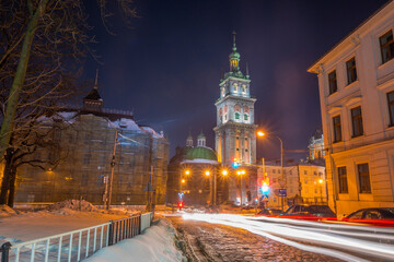 Fototapeta premium Night Lviv old city architecture in the winter season. Buildings highlighted by the illumination