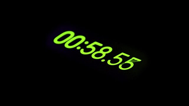 Second countdown, thin numbers font on black background. Close-up. Selective focus.