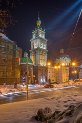 Obraz premium Night Lviv old city architecture in the winter season. Buildings highlighted by the illumination