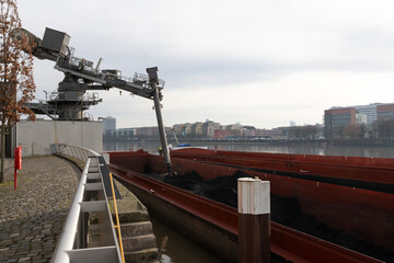 Coal unloading at ship through ship unloading system in Frankfurt Westhafen