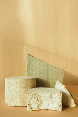 different concrete textured debris on a beige background. podium for advertising and promotion of goods. copy space..