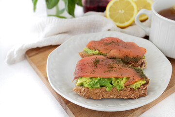 Salmon toast with avocado and dill. Perfect protein breakfast. Food photography