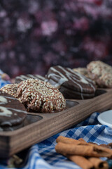 Chocolate and sesame cookies on a wooden board