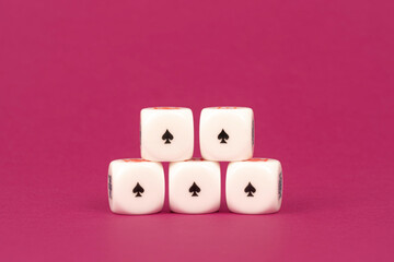 Five poker dice, five aces, winning concept. Bordeaux background
