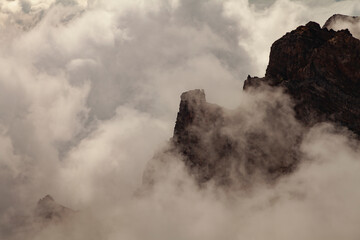 Impressive landscape of clouds and volcanic mountains from the top of the Roque de los Muchachos viewpoint, on the island of La Palma, Canary Islands, Spain.