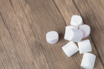 Fototapeta na wymiar Fluffy marshmallows on a wooden table