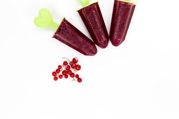 homemade homemade fruit and berry ice cream on a white background on sticks in the form of figurines