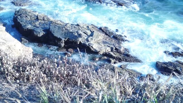 Wide shot of Punta Cometa beach, Mazunte, Oaxaca, Mexico, medium to wide tilt up reveal