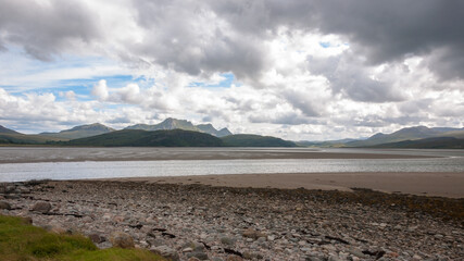 Dornoch Beach clouds over the mountains stones on the beach nc500 north coast 500 scotland