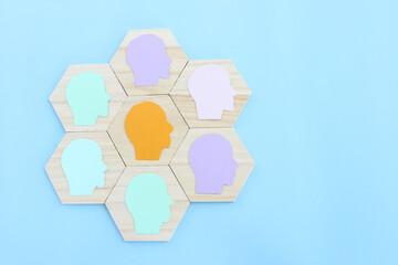 wooden blocks with people icon over blue background, building a strong team, human resources and management concept