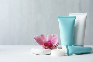Composition with cosmetic products on white table. Space for text