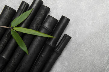 Natural activated bamboo charcoal on concrete background. Realistic pieces charcoal.