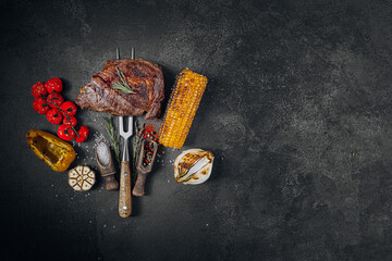barbeque steak on a black slate board - 416582535