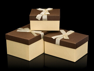 Three cardboard boxes for gifts with bows from silk tape
