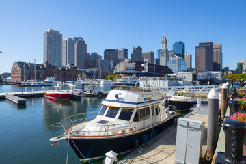Fototapeta na wymiar Yachts at Lewis Wharf in Boston Harbor with Boston skyline and Custom House, city center of Boston, Massachusetts MA, USA. 