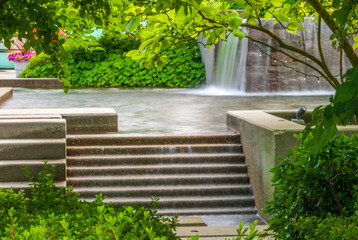 A perfect water landscape with nice pond, flowers and rocks.