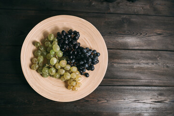 grapes on a plate wooden background fruit freshness