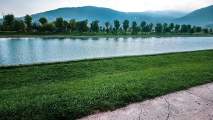 lake and mountains landscape in the park, green natural view