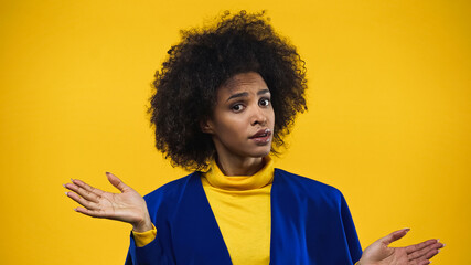African american woman pointing with hands isolated on yellow
