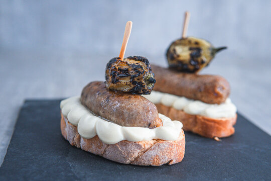 spanish pincho of german sausage on a bread with cream cheese 