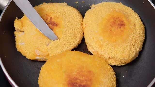 Preparation of frozen cordon bleu schnitzel. Homemade food. Checking readiness