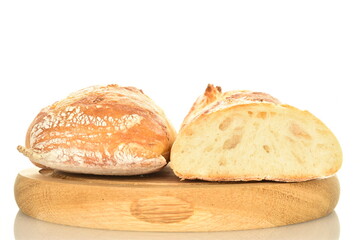 Two halves of delicious freshly baked French baguette on a round wooden tray, close-up, isolated on white.
