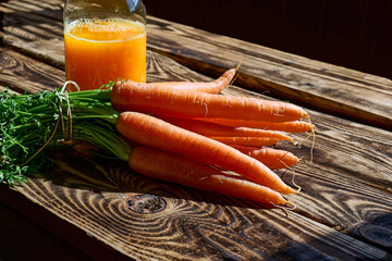 Glass of fresh squeezed carrot juice on the wooden table. Healthy eating, detox, dieting and...