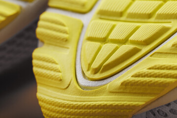 Textured design of the sole of the Tread of a sneaker in yellow Macro.