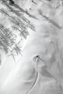 A woman is powder skiing in British Columbia, Canada.
