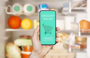 Online grocery delivery app in a mobile phone. Food market service in smartphone. Grocery delivery background concept. Shopping cart.