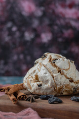 Fluffy meringue muffins with black dry grapes on the table