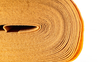 roll of beige dense fabric on a white background, side view, close-up, background, texture