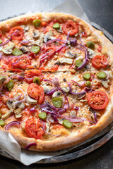 vegetable pizza tomato, pickles, mushroom, olives vegan or vegetarian no meat on the table healthy snack top view copy space food background