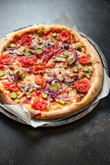 vegetable pizza tomato, pickles, mushroom, olives vegan or vegetarian no meat on the table healthy snack top view copy space food background