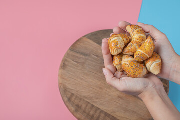 Fried caucasian mutaki cookies on a wooden board on pink blue background