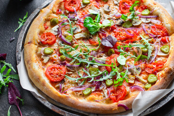 vegetable pizza tomato, pickles, mushroom, olives vegan or vegetarian no meat on the table healthy snack top view copy space food background